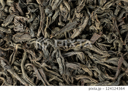 Black large leaf tea leaves macro texture. 124124364