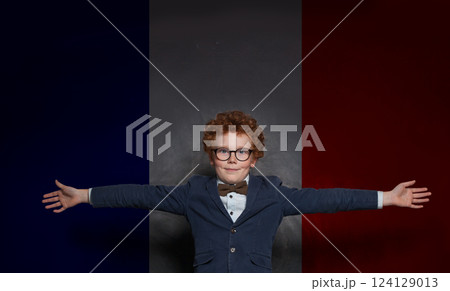 Young child boy on French flag background. Education, travel, school Young child boy on French flag background. Education, travel, school 124129013