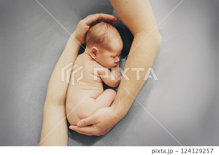A newborn baby is wrapped in diapers with a wool cap in a basket. Swaddling, maternity hospital, family, ivf, life planning, parenting. A mother's love for her child. Baby food. High quality photo A newborn baby is wrapped in diapers with a wool cap in a basket. Swaddling, maternity hospital, family, ivf, life planning, parenting. A mother's love for her child. Baby food. High quality photo 124129257