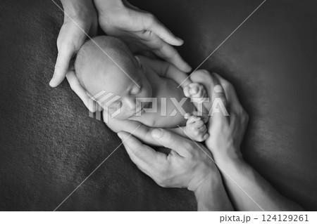 A newborn baby is wrapped in diapers with a wool cap in a basket. Swaddling, maternity hospital, family, ivf, life planning, parenting. A mother's love for her child. Baby food. High quality photo 124129261