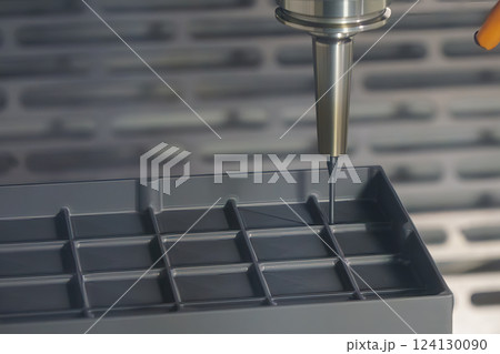 The CNC milling machine cutting the graphite electrode parts. The CNC milling machine cutting the graphite electrode parts. 124130090