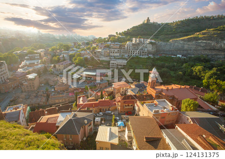 Beautiful sunny landscape of Tbilisi and green mountains on the background of cloudy sky Beautiful sunny landscape of Tbilisi and green mountains on the background of cloudy sky 124131375