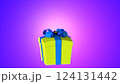 Yellow Gift Box with Blue Ribbon on Glowing Purple Background. 124131442