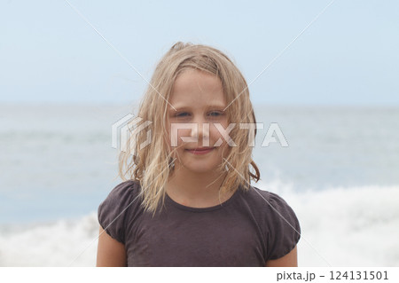 Child girl 7 years old on sea beach, closeup portrait Child girl 7 years old on sea beach, closeup portrait 124131501