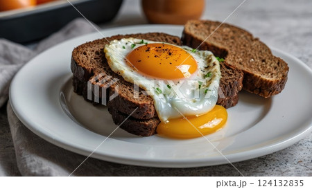 Sandwich of black bread with fried egg on white plate, home food, home breakfast Sandwich of black bread with fried egg on white plate, home food, home breakfast 124132835