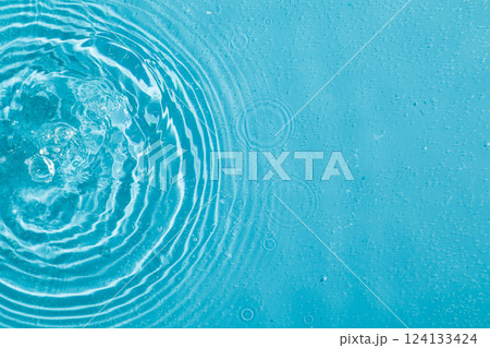 drops on water with circles on a blue background 124133424