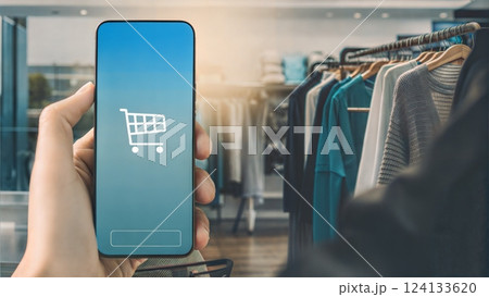 Person shopping online with a smartphone in a stylish retail store Person shopping online with a smartphone in a stylish retail store 124133620