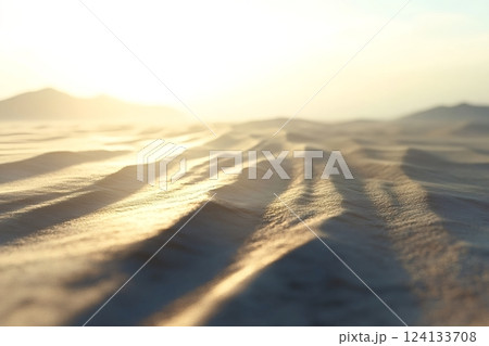 Golden sunrise illuminating desert sand dunes 124133708
