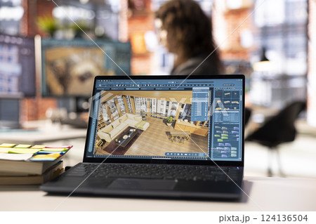 Architectural designer works on a digital home design project, using a 3D modeling program to arrange furniture. The software with advanced user interface for professional rendering. 124136504
