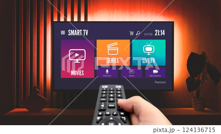 Man watching TV, remote control in hand Man watching TV, remote control in hand 124136715
