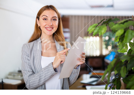 Female secretary holding document in hands Female secretary holding document in hands 124139668