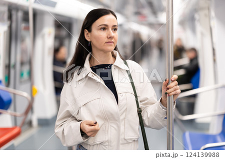 Portrait of beautiful brunette in subway wagon 124139988