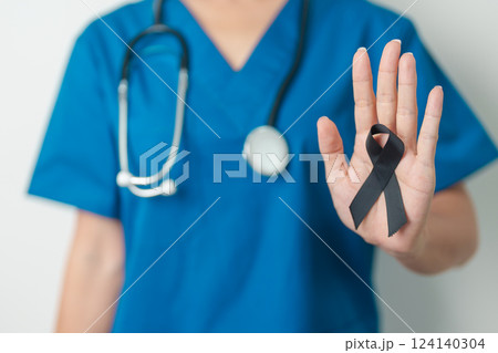 Melanoma and skin cancer, Vaccine injury awareness month and rest in peace concepts. doctor holding black Ribbon Melanoma and skin cancer, Vaccine injury awareness month and rest in peace concepts. doctor holding black Ribbon 124140304