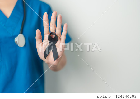 Melanoma and skin cancer, Vaccine injury awareness month and rest in peace concepts. doctor holding black Ribbon 124140305
