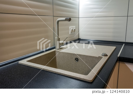 Granite sink and water faucet in new modern kitchen interior Granite sink and water faucet in new modern kitchen interior 124140810