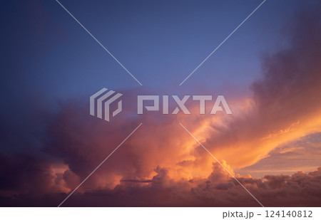 Getting dark at sundown. Sunset sky with scattered clouds of bright colors 124140812