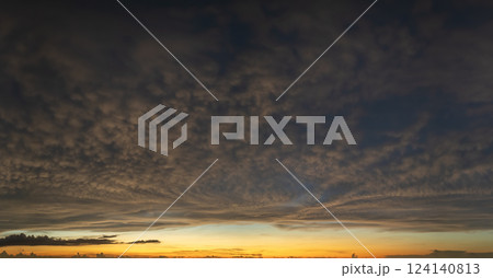 Getting dark at sundown. Sunset sky with scattered clouds of bright colors 124140813