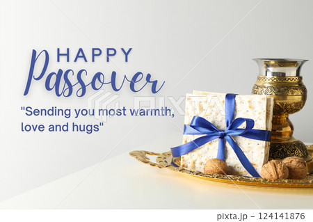 Passover, matzah with a bowl, nuts and greeting text, on a light background 124141876