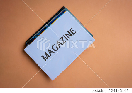 Stack of magazines with word Magazine on white cover. 124143145