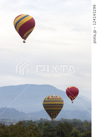 Colorful hot air balloons flying over mountain 124143299