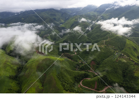 Landscape of Morning Mist with Mountain Layer. mountain ridge and clouds in rural jungle bush forest Landscape of Morning Mist with Mountain Layer. mountain ridge and clouds in rural jungle bush forest 124143344