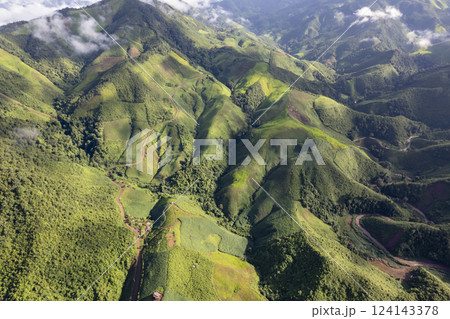 Landscape of Morning Mist with Mountain Layer. mountain ridge and clouds in rural jungle bush forest 124143378