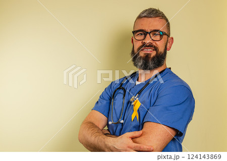 Male medical professional smiling in scrubs with stethoscope in care clinic Male medical professional smiling in scrubs with stethoscope in care clinic 124143869