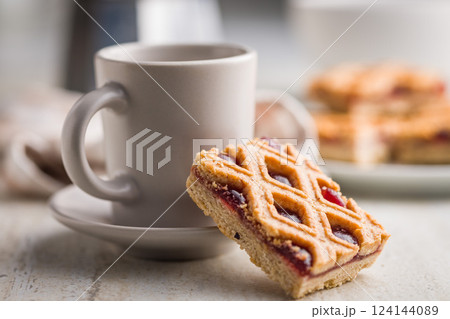 Sweet linzer cake and coffee cup on kitchen table. 124144089