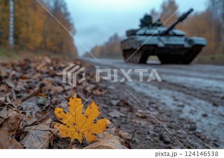 autumn leaves in forest on a foreground and military equipment on the background 124146538
