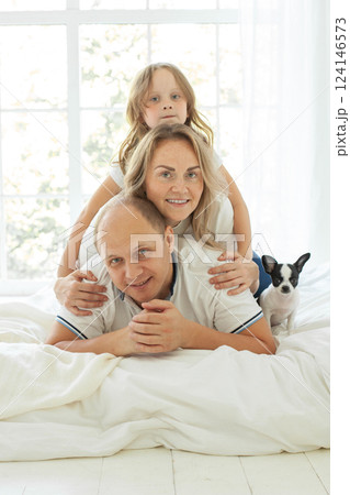 Smiling family relaxing on the couch together at home 124146573