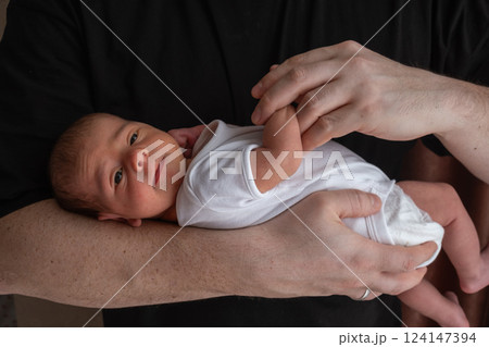 Newborn Baby Cradled in Hand Newborn Baby Cradled in Hand 124147394
