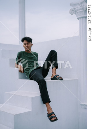 happy man sitting on stairs happy man sitting on stairs 124147772