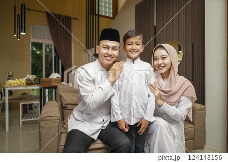 Portrait of the Indonesian Muslim family celebrating Eid Mubarak. Concept of Happy Lebaran, Eid Al Fitr, Idul Fitri, and Ramadan Mubarak celebration 124148156
