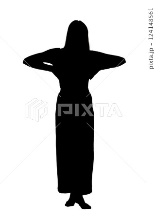 A woman in a long dress stands with her hands on her head 124148561