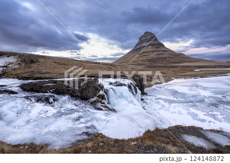 Panoramic view of Kirkjufellsfoss waterfall and Kirkjufell mountain on peninsula, Iceland 124148872