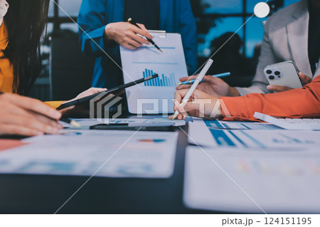 Business Team Analyzing Financial Data in Modern Office Business Team Analyzing Financial Data in Modern Office 124151195