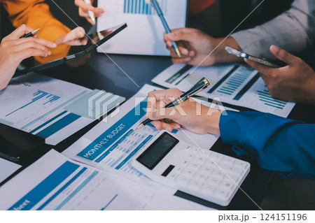 Business Team Analyzing Financial Data in Modern Office Business Team Analyzing Financial Data in Modern Office 124151196