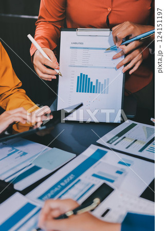 Business Team Analyzing Financial Data in Modern Office Business Team Analyzing Financial Data in Modern Office 124151197