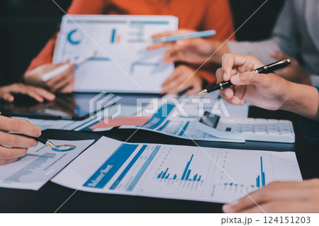 Business Team Analyzing Financial Data in Modern Office Business Team Analyzing Financial Data in Modern Office 124151203