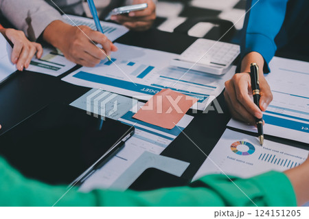 Business Team Analyzing Financial Data in Modern Office Business Team Analyzing Financial Data in Modern Office 124151205