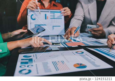 Business Team Analyzing Financial Data in Modern Office Business Team Analyzing Financial Data in Modern Office 124151211