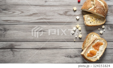 Freshly sliced bread with cream cheese and fruit spread on a rustic wooden table 124151824
