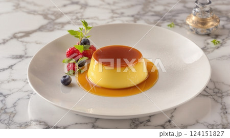Delicious Argentine dulce de leche flan served with fresh berries on a marble table 124151827