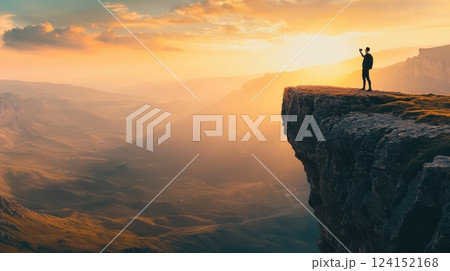 Travel vlogger capturing an epic sunrise view from a mountain edge. Using phone stabilizer 124152168