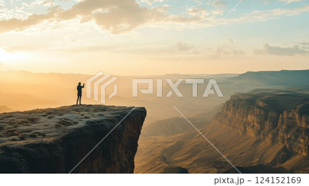 Freedom and adventure, traveler filming a vlog on a windy mountain peak. Using phone stabilizer 124152169