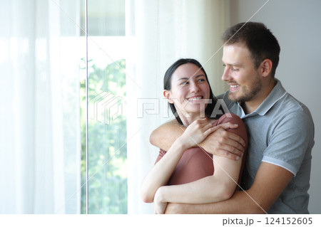 Happy interracial couple in love looking each other at home 124152605