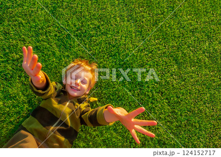 The child goes in for sports at the stadium. The boy training before playing football. The child goes in for sports at the stadium. The boy training before playing football. 124152717