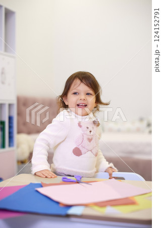 happy little child girl using multi-color paper while sitting by table, Children creativity 124152791