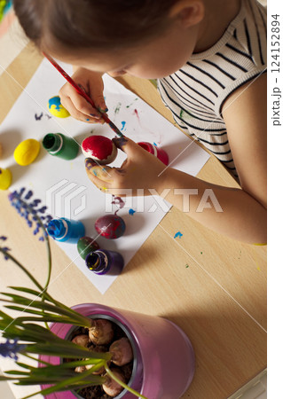 Little child girl paint Easter eggs at home. kid is preparing for Easter. Little child girl paint Easter eggs at home. kid is preparing for Easter. 124152894