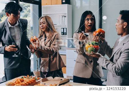 Asian office colleagues and friends enjoy a daytime BBQ with pizza and beer, celebrating Halloween and cheering for their favorite soccer team, creating a lively atmosphere filled with joy. Asian office colleagues and friends enjoy a daytime BBQ with pizza and beer, celebrating Halloween and cheering for their favorite soccer team, creating a lively atmosphere filled with joy. 124153220